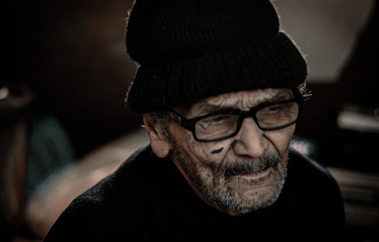 man in black knit cap and black framed eyeglasses