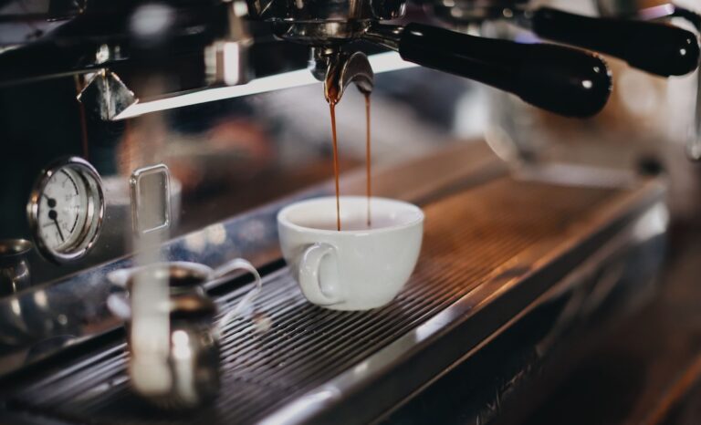 white ceramic cup on brown wooden table