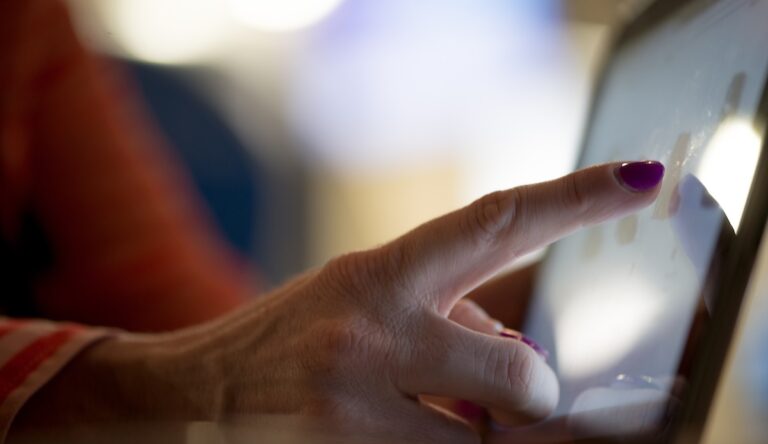 selective focus photography of person pointing at tablet computer forex trading